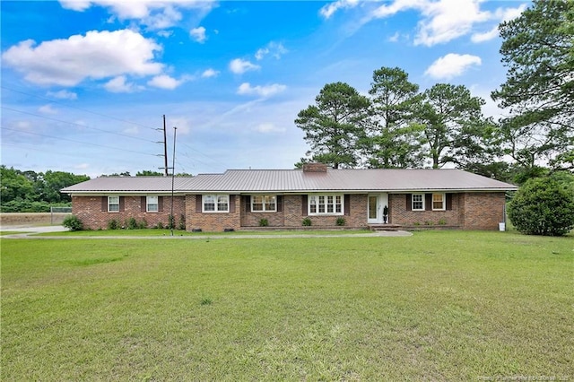 2547 Red Springs Rd, Raeford, NC 28376 - ranch-style home featuring a front lawn, brick siding, metal roof, and a chimney