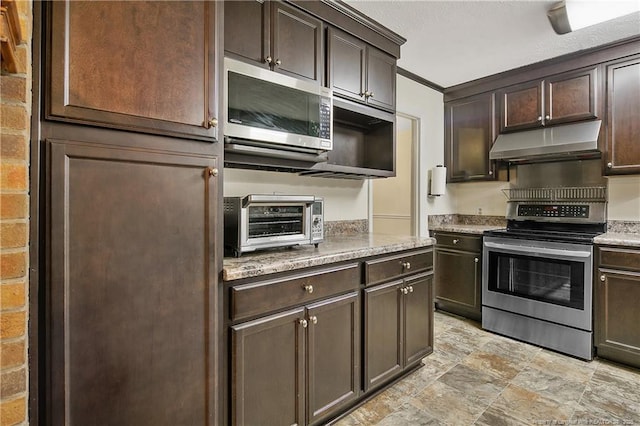 2547 Red Springs Rd, Raeford, NC 28376 - kitchen featuring exhaust hood, appliances with stainless steel finishes, dark brown cabinetry, stone finish flooring, and light stone counters
