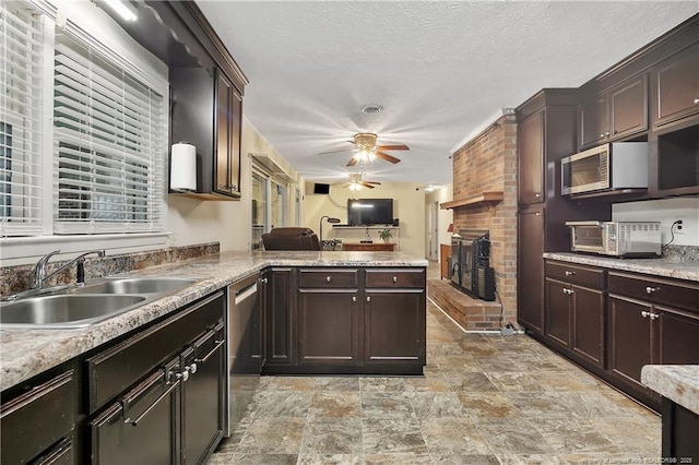 2547 Red Springs Rd, Raeford, NC 28376 - kitchen with stainless steel appliances, a sink, a ceiling fan, stone finish floors, and a brick fireplace