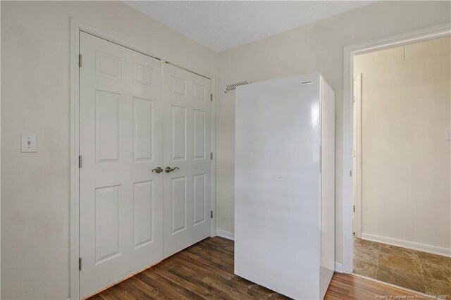2547 Red Springs Rd, Raeford, NC 28376 - unfurnished bedroom with a closet, baseboards, and dark wood-type flooring