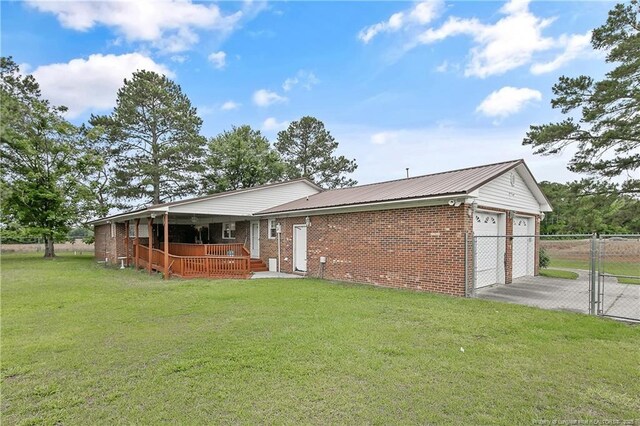 2547 Red Springs Rd, Raeford, NC 28376 - view of front of home featuring brick siding, a gate, an attached garage, and a wooden deck