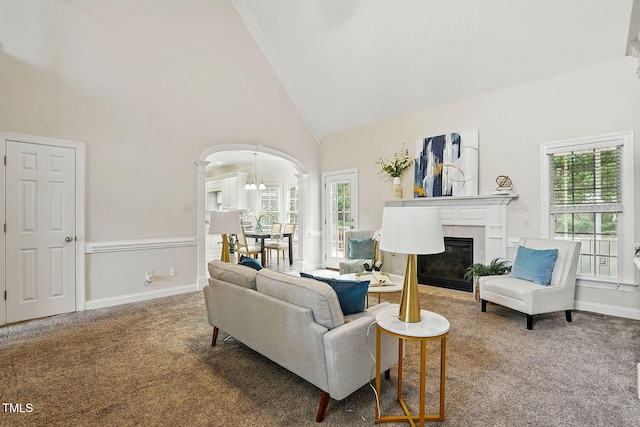 3020 Woods Walk Way, Rocky Mount, NC 27804 - living area with high vaulted ceiling, carpet flooring, arched walkways, ornamental molding, and a glass covered fireplace