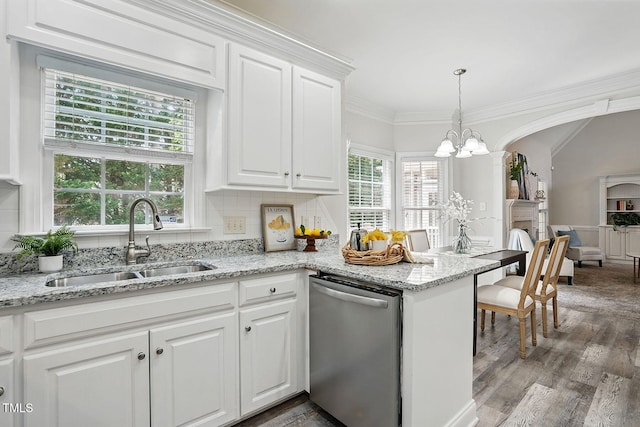 3020 Woods Walk Way, Rocky Mount, NC 27804 - kitchen with dishwasher, a sink, wood finished floors, healthy amount of natural light, and crown molding