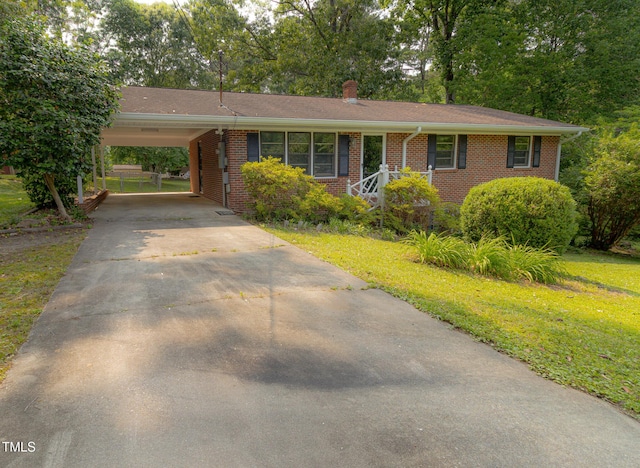 5504 Balsam Pl, Raleigh, NC 27603 - single story home featuring a chimney, concrete driveway, brick siding, an attached carport, and a front yard