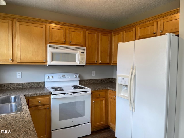78 Ariel St, Lillington, NC 27546 - kitchen with white appliances, brown cabinets, dark countertops, and a textured ceiling