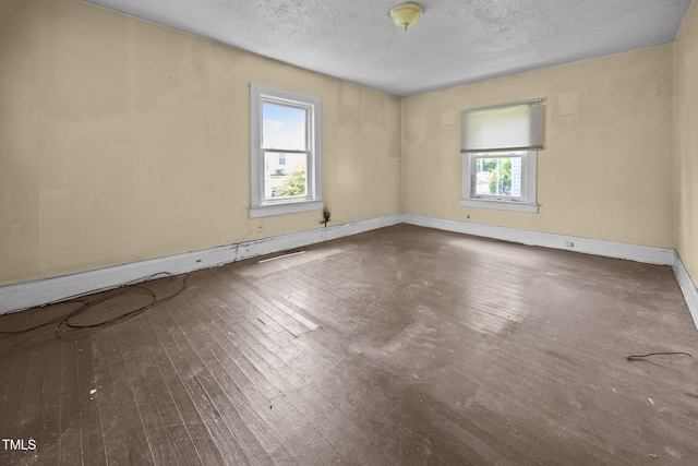 312 W Front St, Oxford, NC 27565 - unfurnished room with wood-type flooring, a textured ceiling, and baseboards