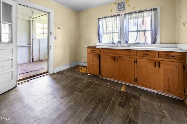 312 W Front St, Oxford, NC 27565 - kitchen featuring brown cabinetry, dark wood-style floors, light countertops, and a sink