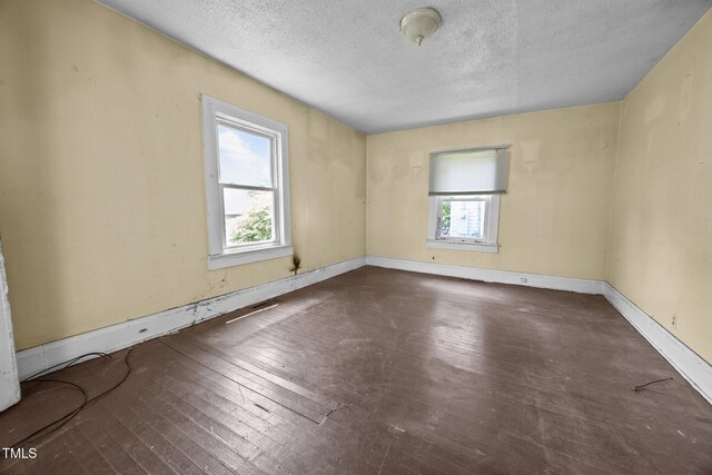 312 W Front St, Oxford, NC 27565 - unfurnished room with hardwood / wood-style flooring, a textured ceiling, and baseboards