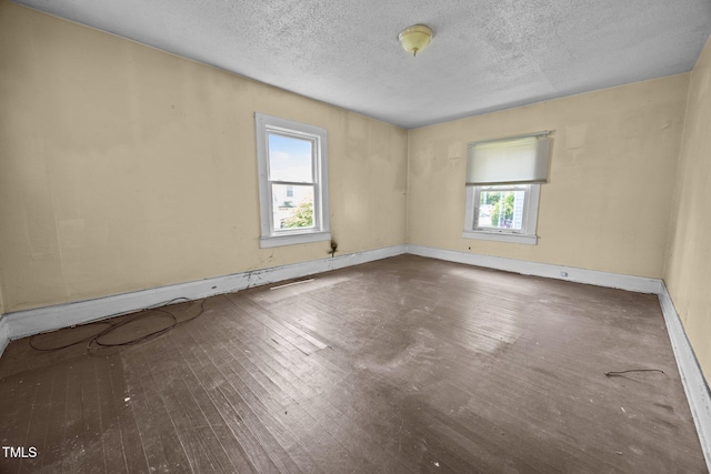 312 W Front St, Oxford, NC 27565 - unfurnished room featuring a textured ceiling, hardwood / wood-style flooring, and baseboards
