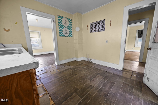 312 W Front St, Oxford, NC 27565 - unfurnished dining area with a sink, baseboards, and dark wood-style flooring