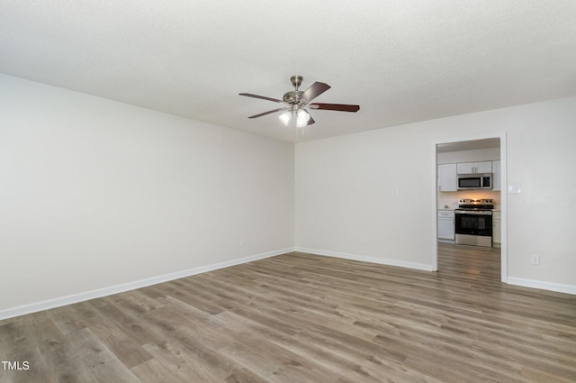 1110 Allgood St, Durham, NC 27704 - spare room with light wood-type flooring, ceiling fan, and baseboards