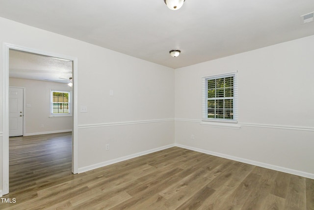 1110 Allgood St, Durham, NC 27704 - unfurnished room with wood finished floors, baseboards, and ceiling fan