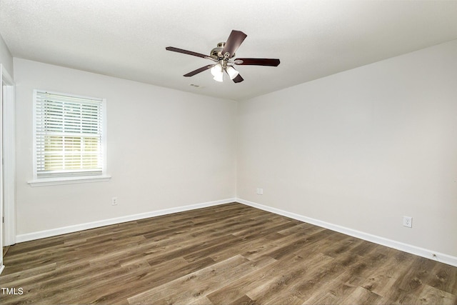1110 Allgood St, Durham, NC 27704 - unfurnished room featuring dark wood finished floors, baseboards, and a ceiling fan