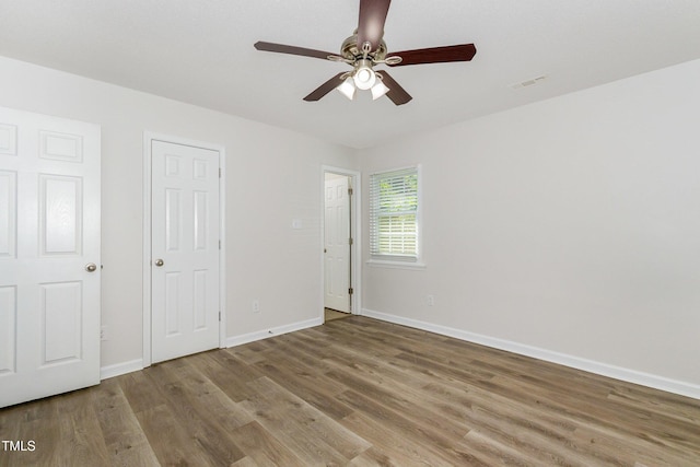 1110 Allgood St, Durham, NC 27704 - unfurnished bedroom featuring wood finished floors, baseboards, and ceiling fan