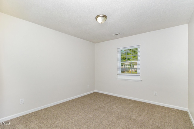 1110 Allgood St, Durham, NC 27704 - carpeted spare room with baseboards and a textured ceiling