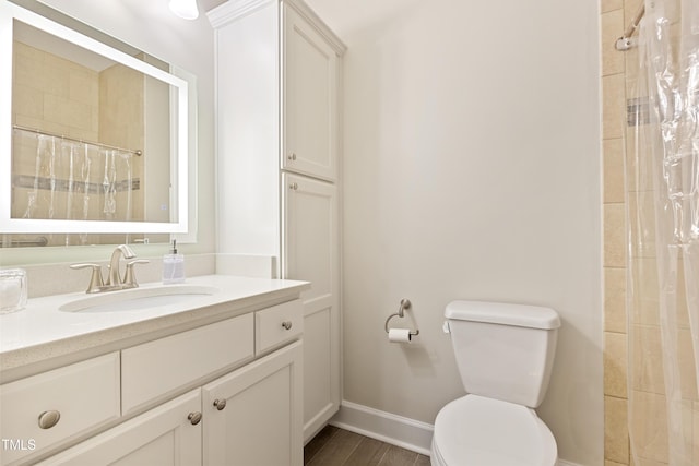 119 Danforth Dr, Cary, NC 27511 - full bathroom with toilet, vanity, baseboards, tiled shower, and wood finished floors