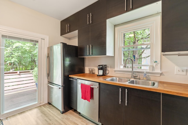 119 Danforth Dr, Cary, NC 27511 - kitchen with stainless steel appliances, a sink, wooden counters, light wood-type flooring, and dark brown cabinets