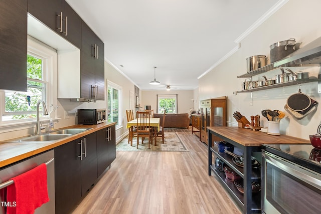 119 Danforth Dr, Cary, NC 27511 - kitchen featuring butcher block counters, stainless steel appliances, ornamental molding, light wood finished floors, and a sink