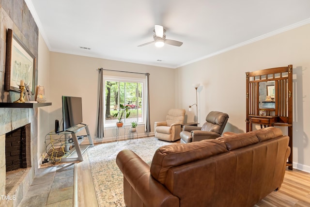 119 Danforth Dr, Cary, NC 27511 - living area with ceiling fan, light wood-type flooring, a fireplace, ornamental molding, and baseboards