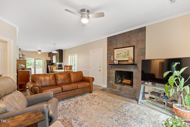 119 Danforth Dr, Cary, NC 27511 - living area featuring a ceiling fan, wood finished floors, ornamental molding, and a tiled fireplace