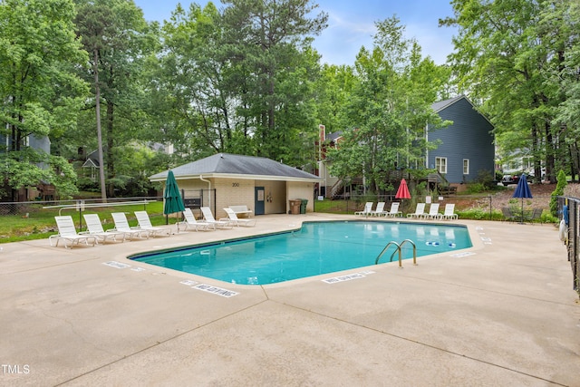 119 Danforth Dr, Cary, NC 27511 - community pool with a patio and view of scattered trees