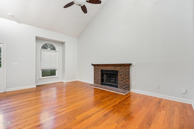 3306 Woodland Park Rd, Durham, NC 27703 - unfurnished living room with ceiling fan, high vaulted ceiling, a fireplace, wood finished floors, and baseboards