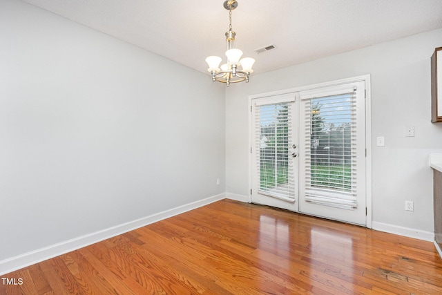 3306 Woodland Park Rd, Durham, NC 27703 - unfurnished room with a chandelier, light wood finished floors, and baseboards