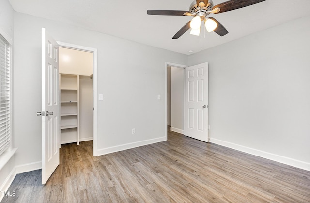 3306 Woodland Park Rd, Durham, NC 27703 - unfurnished bedroom with light wood-style flooring, a spacious closet, baseboards, and a closet