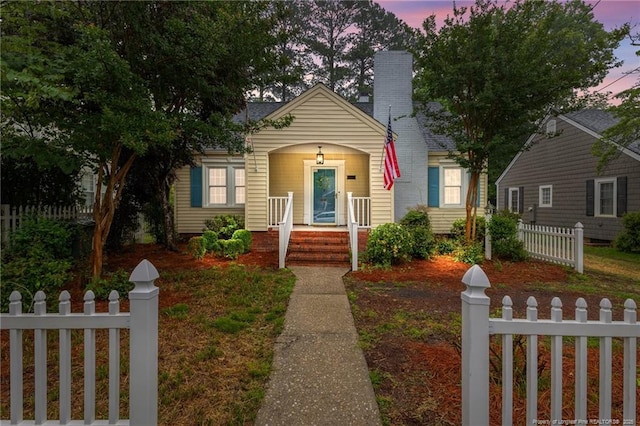 123 Ellington St, Fayetteville, NC 28305 - bungalow-style house with covered porch and a chimney