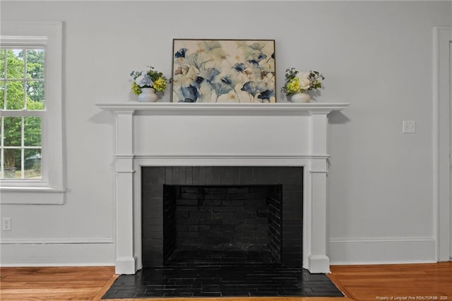 123 Ellington St, Fayetteville, NC 28305 - detailed view of a fireplace with flush hearth, wood finished floors, and baseboards