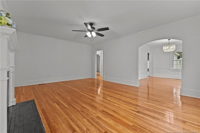 123 Ellington St, Fayetteville, NC 28305 - unfurnished living room featuring light wood-style floors, ceiling fan, arched walkways, crown molding, and baseboards
