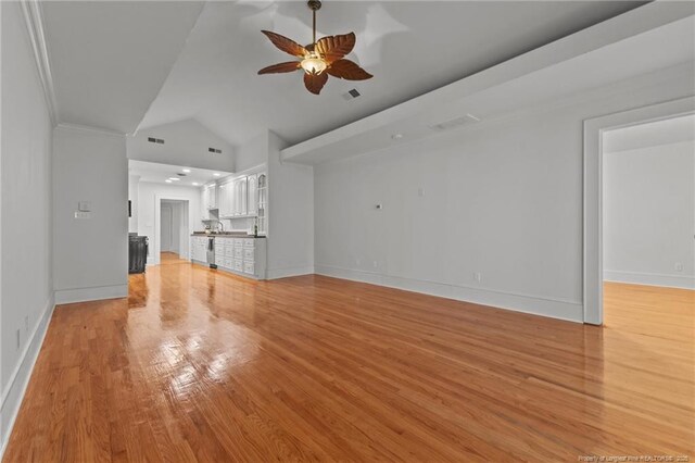 123 Ellington St, Fayetteville, NC 28305 - unfurnished living room featuring ceiling fan, vaulted ceiling, light wood-style flooring, baseboards, and crown molding
