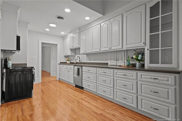 123 Ellington St, Fayetteville, NC 28305 - kitchen with stainless steel dishwasher, dark countertops, white cabinets, recessed lighting, and light wood finished floors