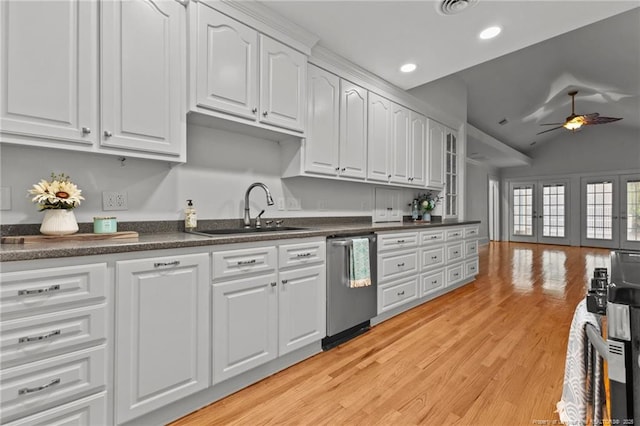 123 Ellington St, Fayetteville, NC 28305 - kitchen featuring dishwasher, a sink, dark countertops, white cabinetry, and lofted ceiling