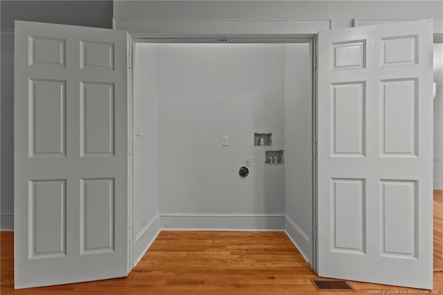123 Ellington St, Fayetteville, NC 28305 - washroom featuring washer hookup, light wood-type flooring, hookup for an electric dryer, and baseboards