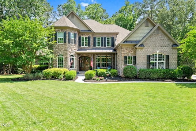 7552 Hasentree Club Dr, Wake Forest, NC 27587 - view of front of home featuring a front lawn, brick siding, a shingled roof, and stone siding