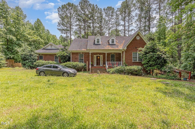 3304 Black Stallion Ct, Zebulon, NC 27597 - cape cod-style house featuring a porch, brick siding, and a front lawn