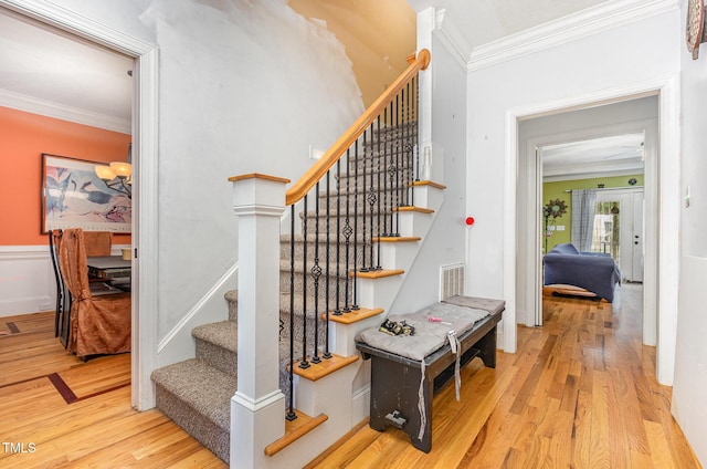 3304 Black Stallion Ct, Zebulon, NC 27597 - stairway with ornamental molding and wood finished floors