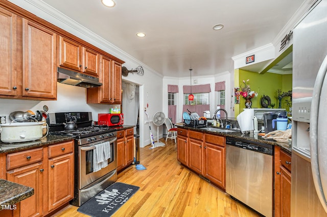 3304 Black Stallion Ct, Zebulon, NC 27597 - kitchen featuring stainless steel appliances, under cabinet range hood, light wood finished floors, brown cabinets, and ornamental molding