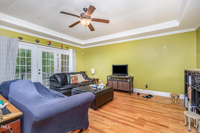 3304 Black Stallion Ct, Zebulon, NC 27597 - living room featuring wood finished floors, a raised ceiling, french doors, crown molding, and ceiling fan