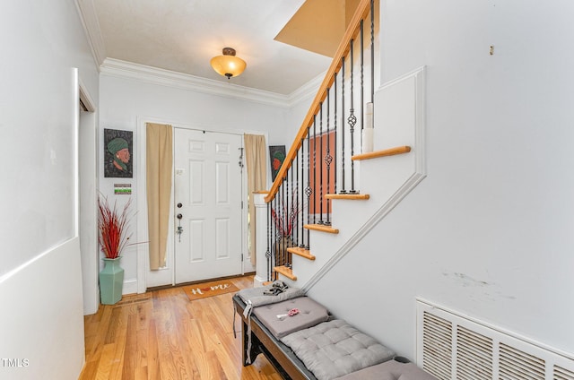 3304 Black Stallion Ct, Zebulon, NC 27597 - foyer featuring crown molding, light wood-type flooring, stairway, and radiator heating unit