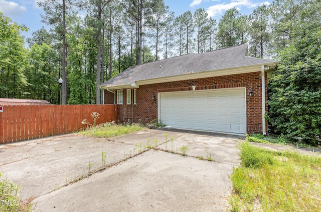 3304 Black Stallion Ct, Zebulon, NC 27597 - view of front facade with brick siding, concrete driveway, a shingled roof, and a garage