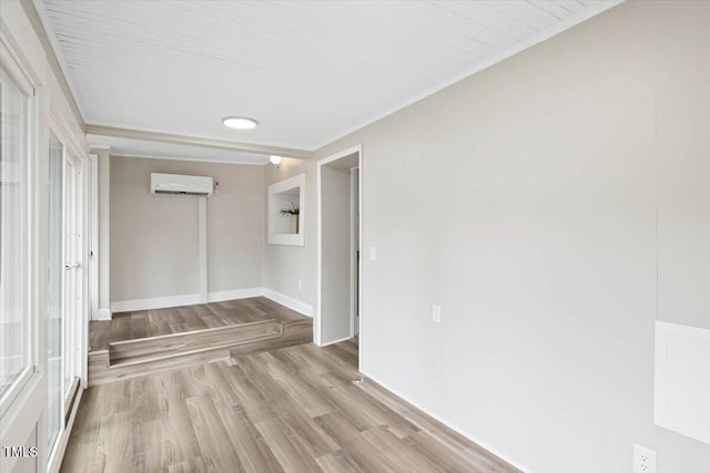 205 Forest Hill Ave, Rocky Mount, NC 27804 - spare room featuring an AC wall unit, light wood-style floors, baseboards, and crown molding