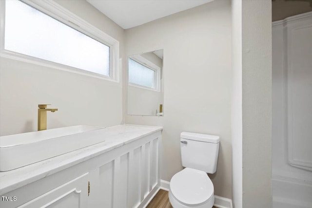 205 Forest Hill Ave, Rocky Mount, NC 27804 - bathroom with toilet, vanity, and baseboards