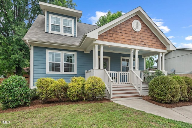 415 Dupree St, Durham, NC 27707 - view of front of home with covered porch, a front yard, and a shingled roof