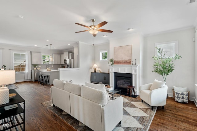 415 Dupree St, Durham, NC 27707 - living room with a ceiling fan, crown molding, a glass covered fireplace, dark wood-style flooring, and recessed lighting