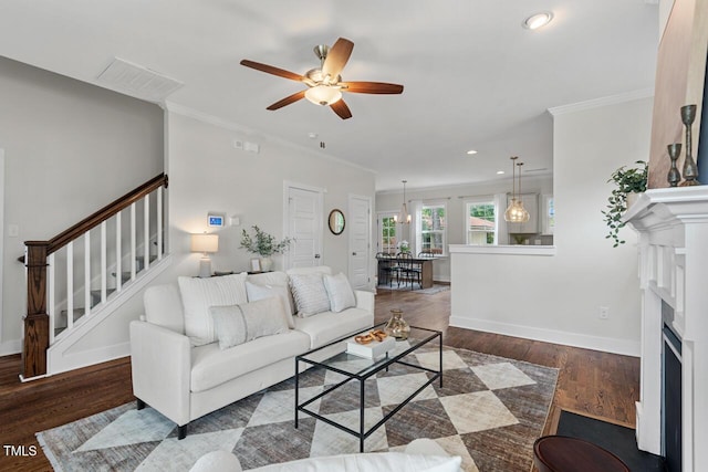 415 Dupree St, Durham, NC 27707 - living area featuring stairs, ceiling fan, ornamental molding, wood finished floors, and a fireplace with flush hearth