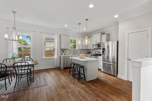 415 Dupree St, Durham, NC 27707 - kitchen with appliances with stainless steel finishes, a sink, light countertops, a center island, and dark wood-type flooring