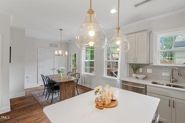 415 Dupree St, Durham, NC 27707 - kitchen with stainless steel dishwasher, a sink, ornamental molding, light countertops, and baseboards