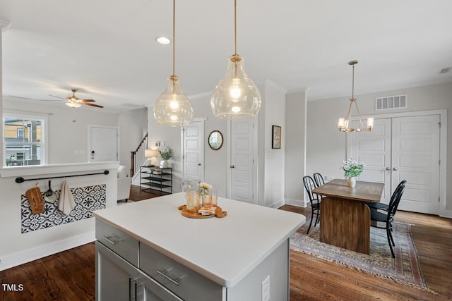 415 Dupree St, Durham, NC 27707 - kitchen with gray cabinets, light countertops, ceiling fan, dark wood-style flooring, and crown molding